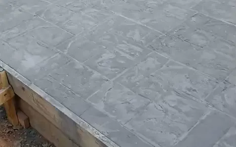 Freshly stamped concrete patio with tile pattern